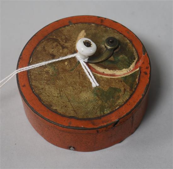 A mid 19th century Swiss tinplate circular musical box, playing a single tune, diam. 7cm